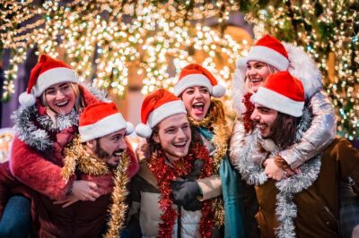 Happy group of friends wearing Santa Claus hat