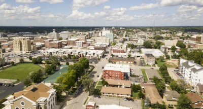 The downtown city skyline and buidlings of Springfield MO under partly cloudy skies aerial perspective